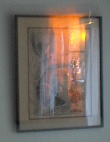 A rubbing of a Mayan/Aztec/Toltec frieze with reflections of setting sun through window over Altar...